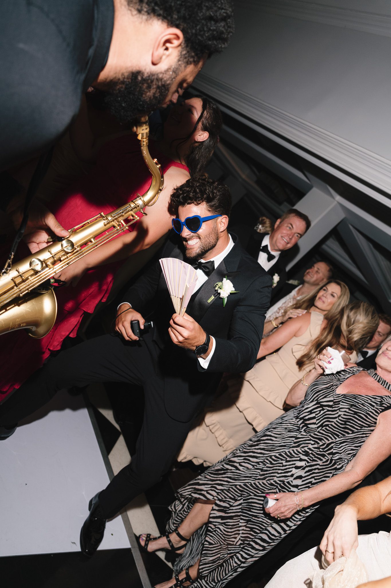 a sax player on the dance floor performing for guests.