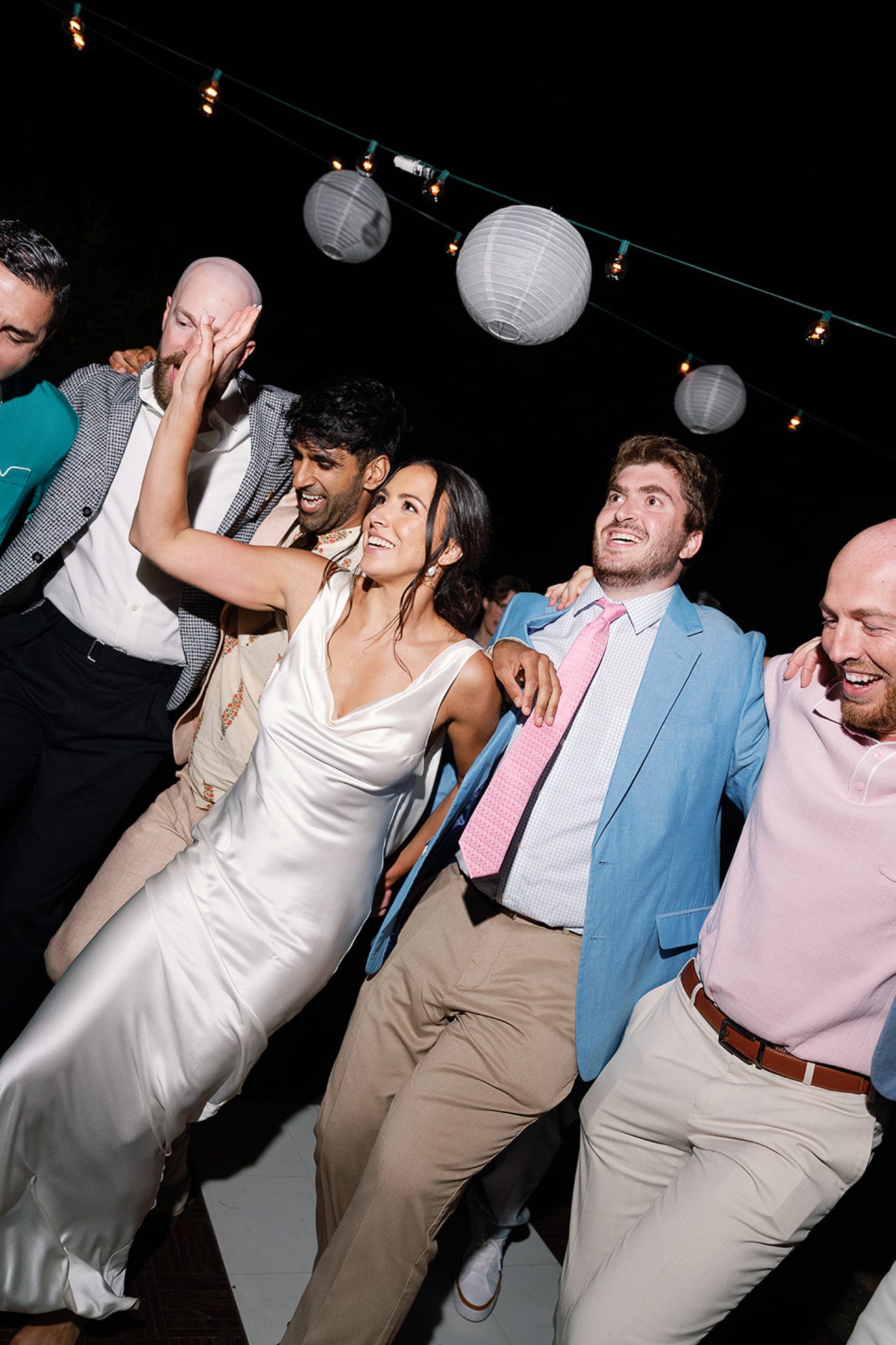 the bride dancing with the groomsmen. 