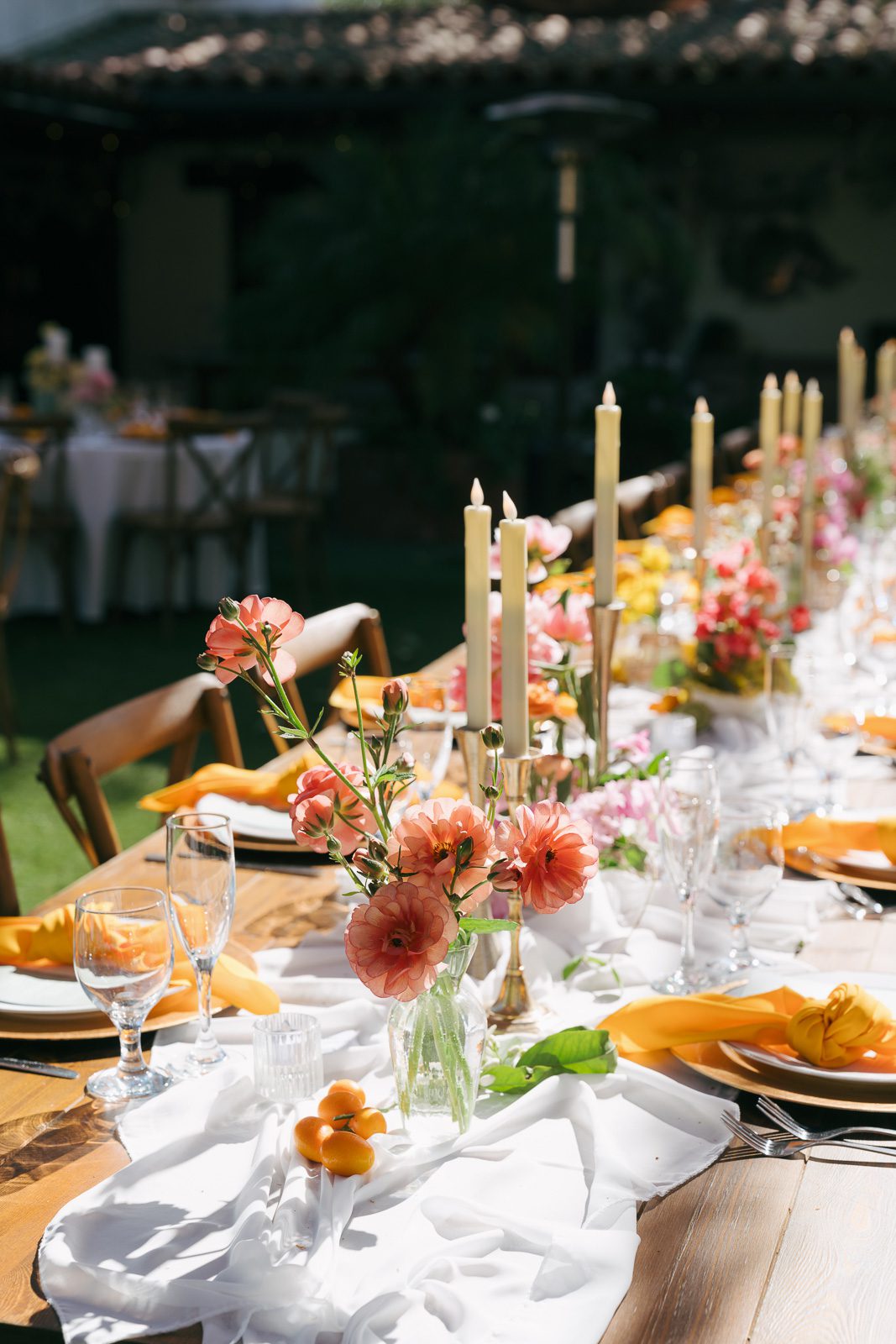 flowers, candles, dinnerware and a runner. 