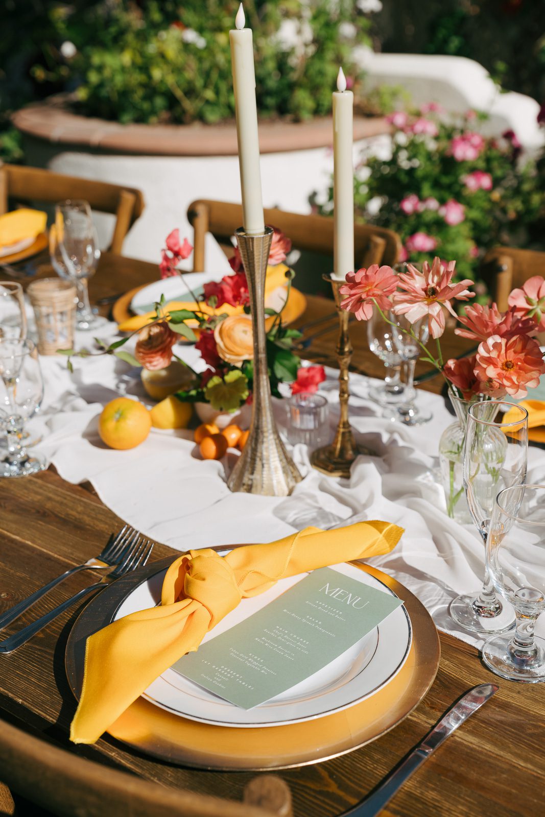 a dinner place with an orange napkin and the dinner menu during a Tivoli Italian Villa wedding. 