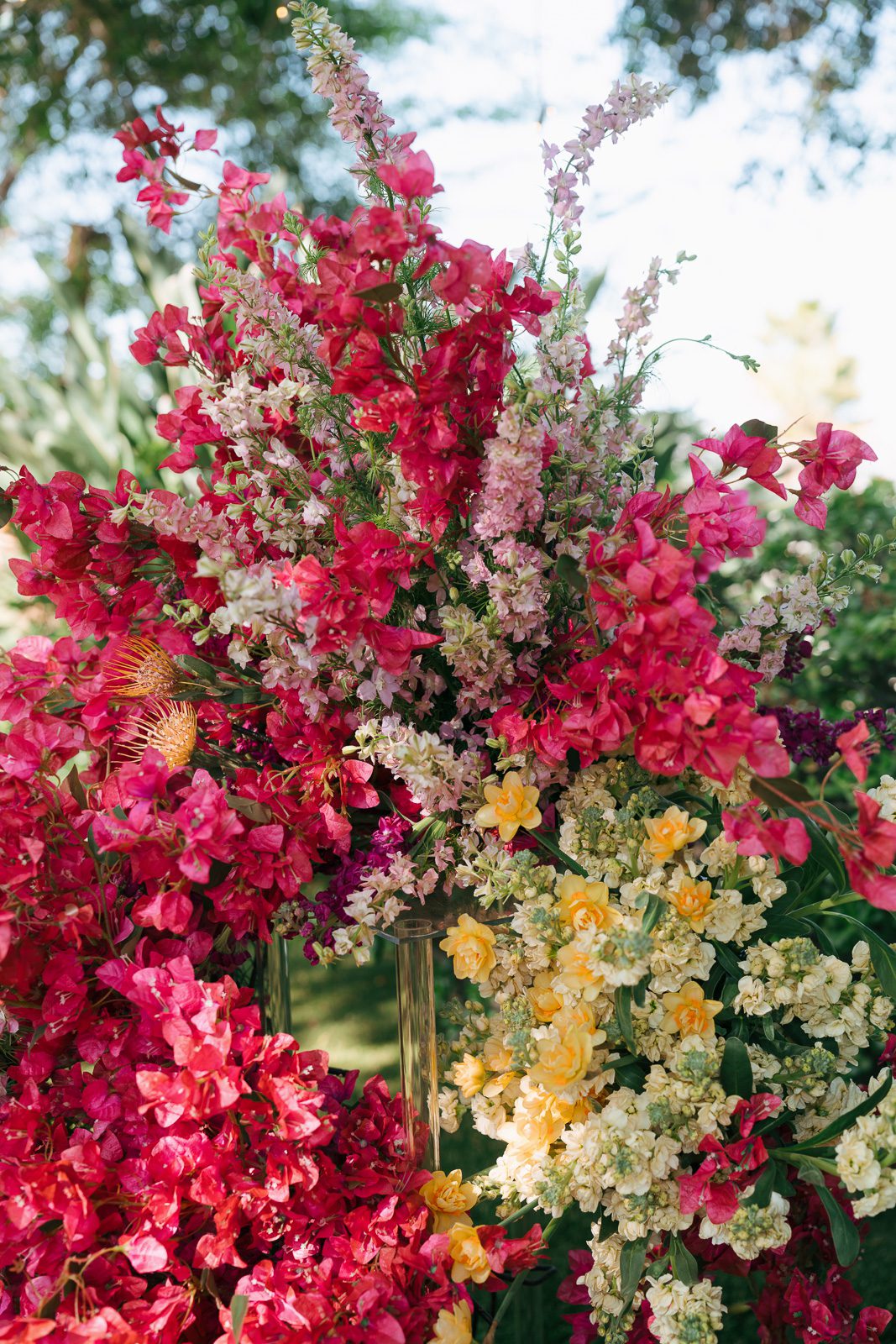 a bouquet of flowers, filled with reds, yellows, and creams. 