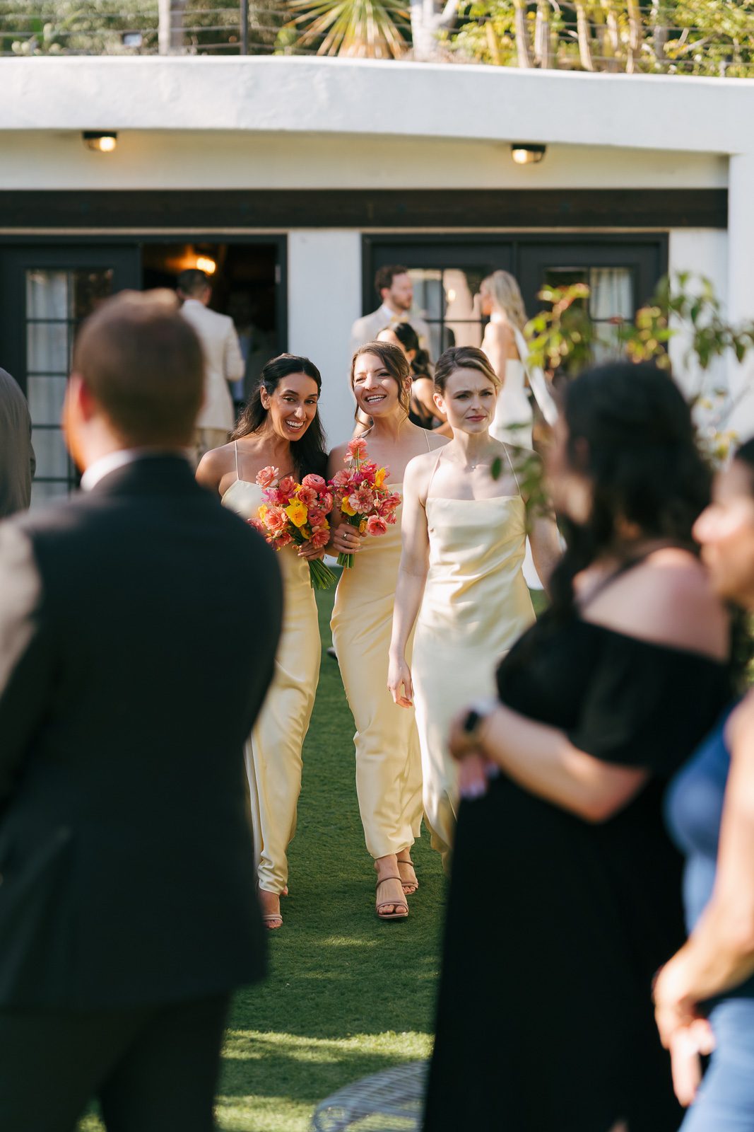 bridesmaids entering the cocktail hour after the Tivoli Italian Villa wedding ceremony. 
