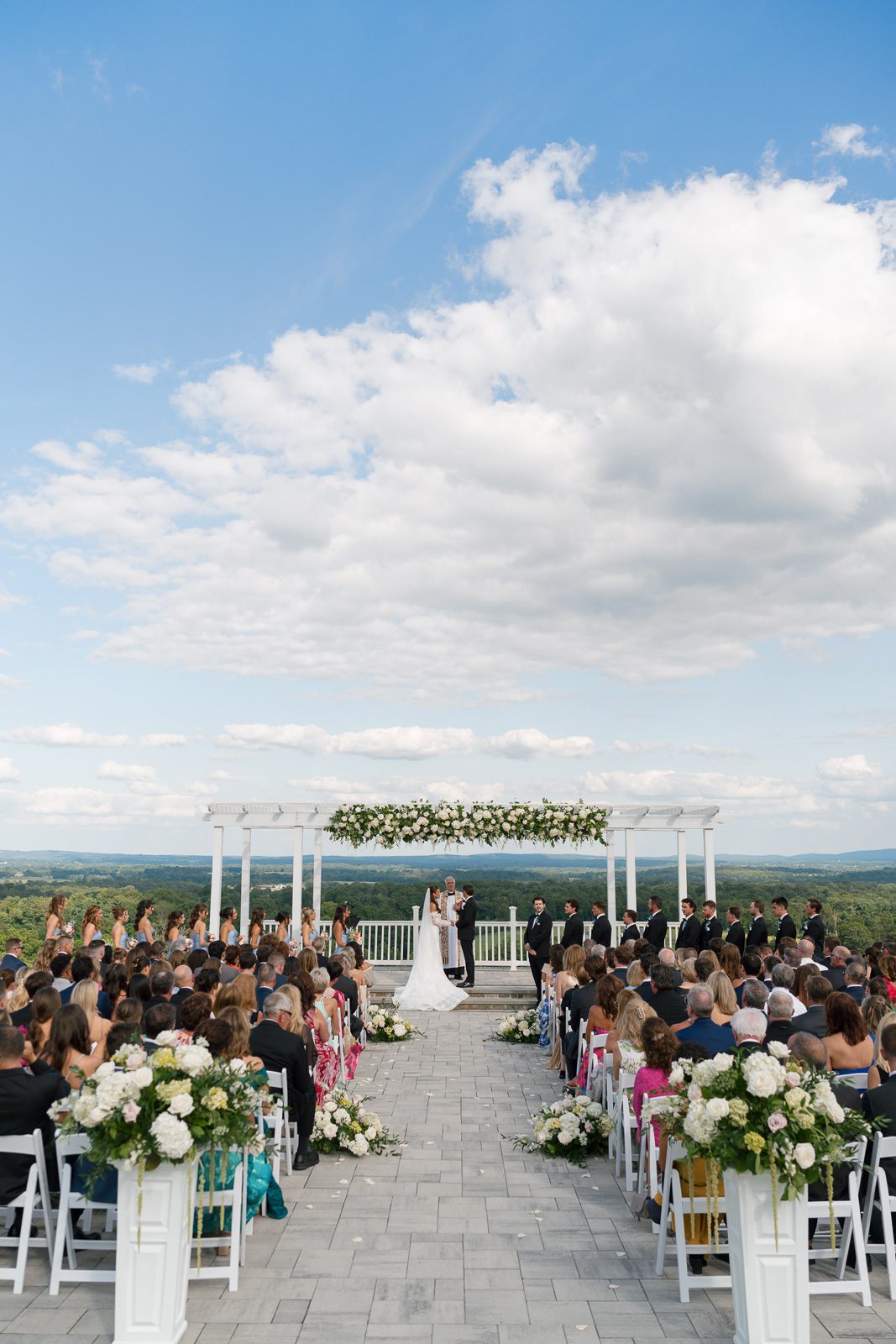 the newlyweds at the altar while their guests watch on during their The View At Bluemont wedding