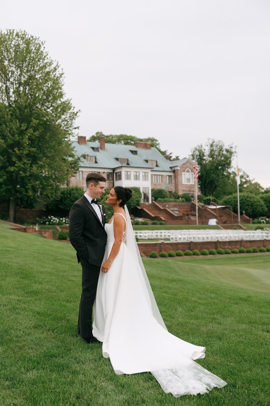 the newlyweds sharing a private moment outside on a grassy hill as part of their wedding day timeline. 