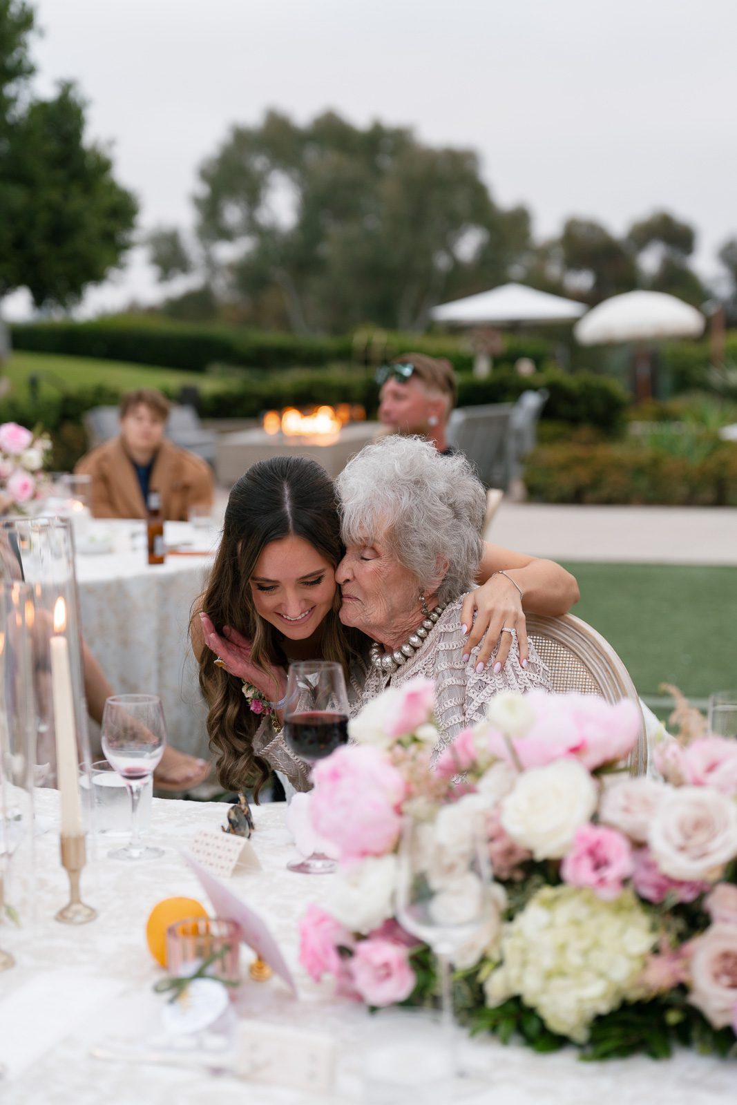 the bride hugging her grandma during her wedding reception. 