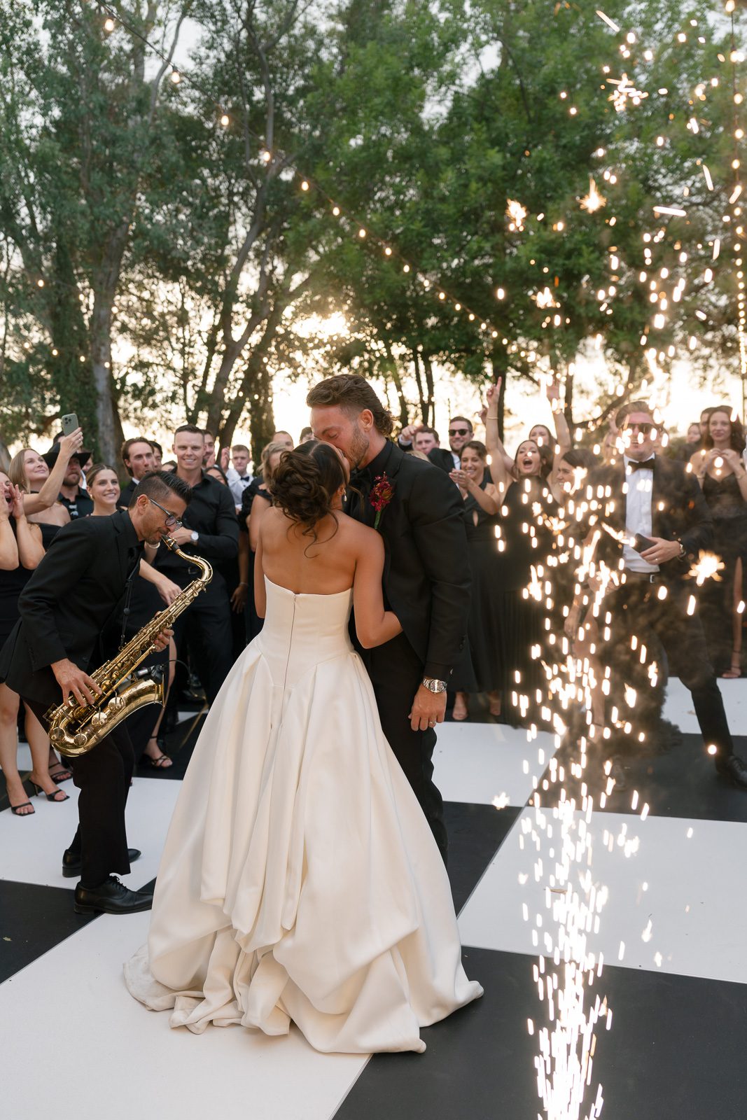 a sax player performing during the newlywed's first dance, one way how they made their wedding unique. 