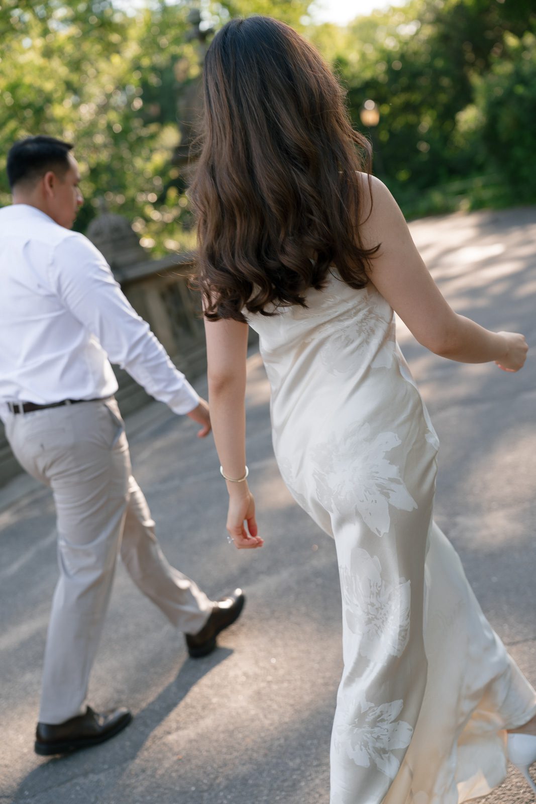 couple walking through central park during their NYC engagement photos. 