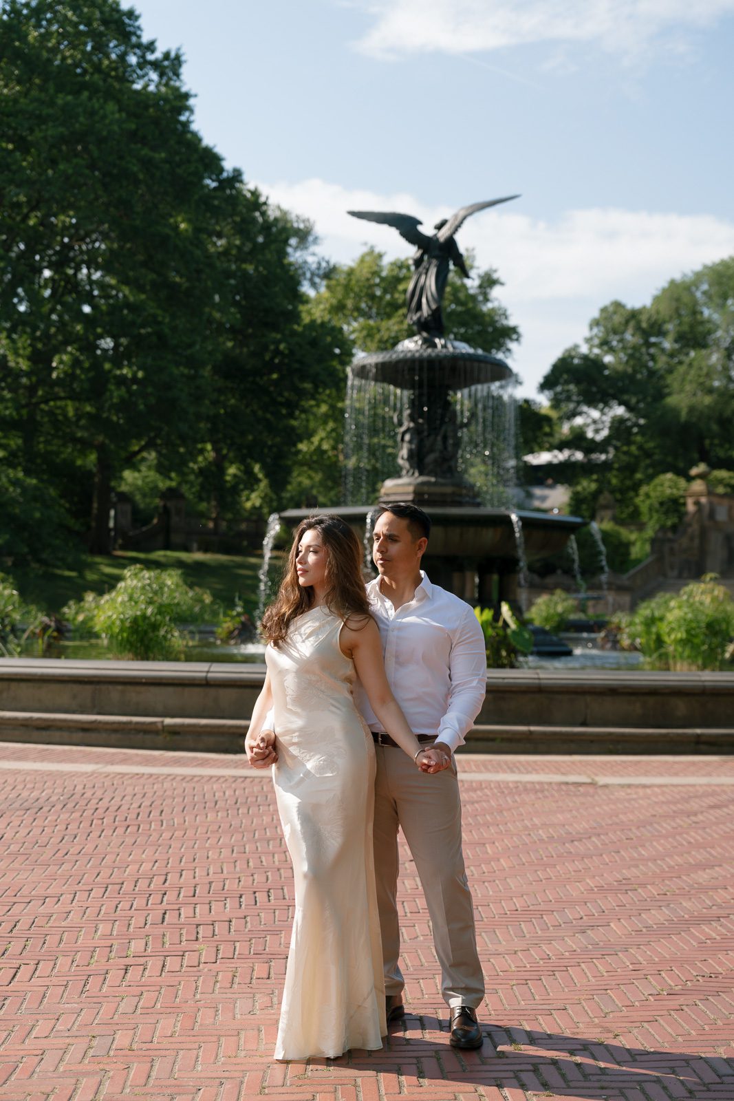 couple posing in front of bethesda fountain during their NYC engagement photos. 