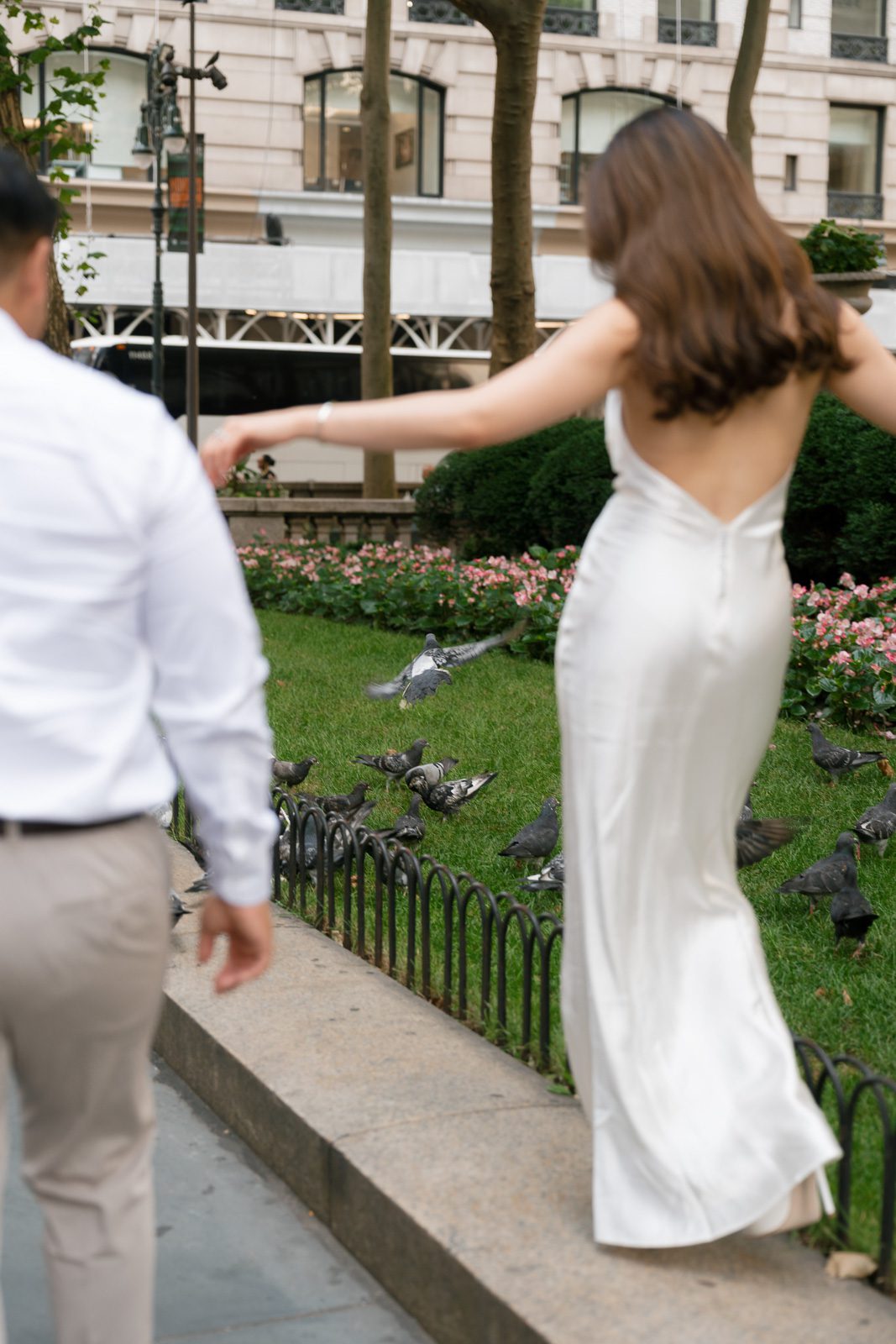 girlfriend walking along a retaining wall during her NYC engagement photos. 