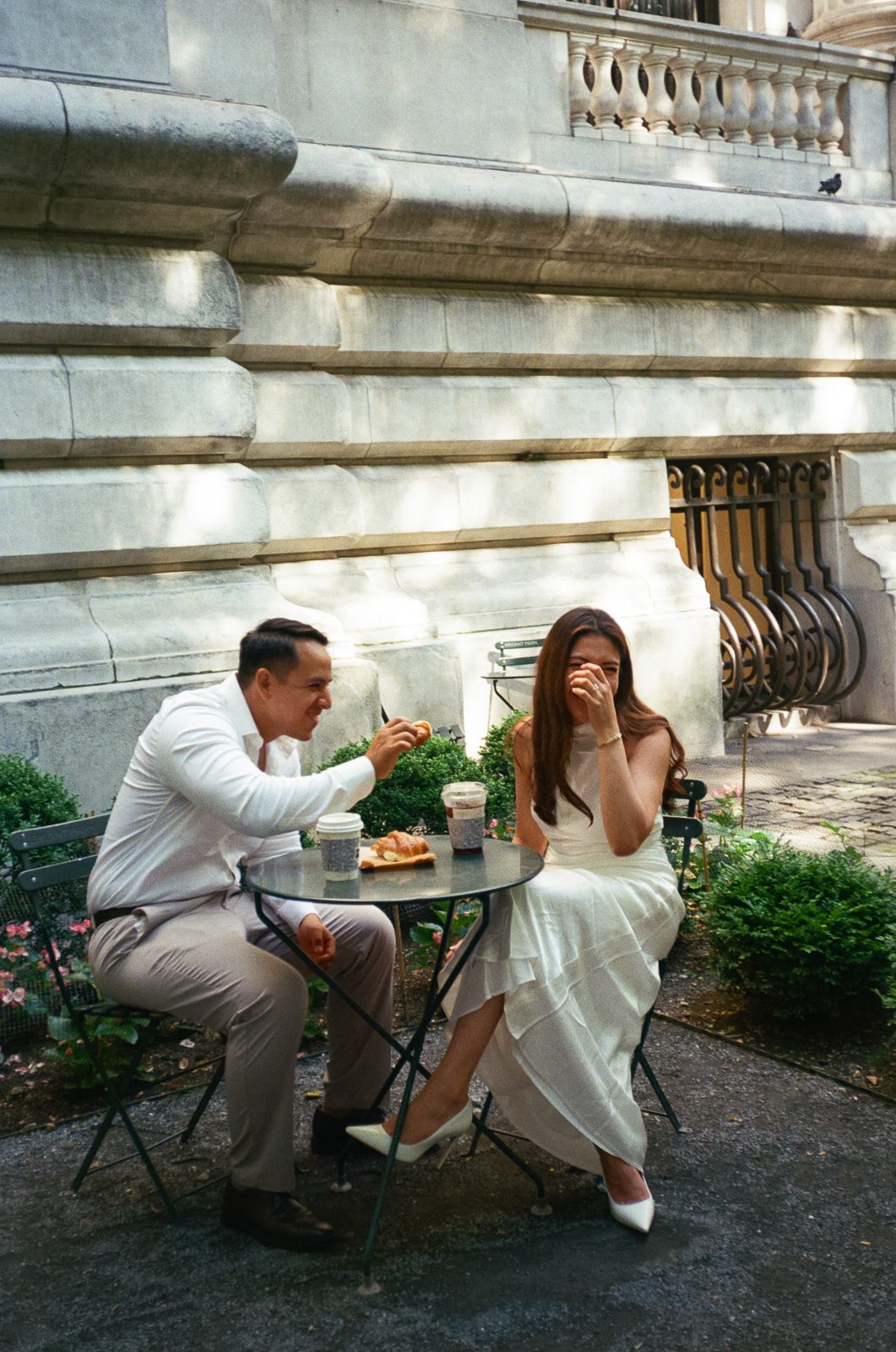 couple sitting on an outdoor table enjoying breakfast in new york. 